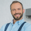 smiling-bearded-repairman-posing-with-crossed-arms-9WEV98W-1.jpg